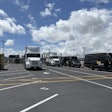 Zeem Solutions' LAX depot, featuring parked Volvo VNR Electric Class 8 semis and Mercedes-Benz eSprinter vans.