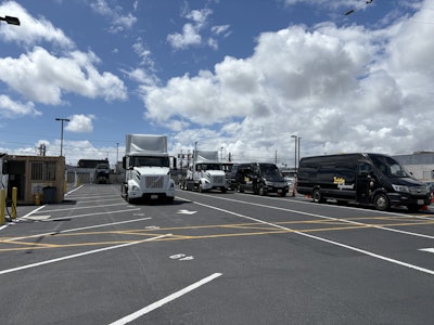 Zeem Solutions' LAX depot, featuring parked Volvo VNR Electric Class 8 semis and Mercedes-Benz eSprinter vans.