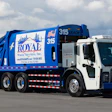 A parked Mack LR Electric garbage truck painted in blue and white Royal Waste Services livery.
