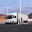 A rendering of a white Tesla Semi at a charging station.