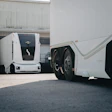 Einride's battery-electric autonomous trucks in action at an industrial warehouse.