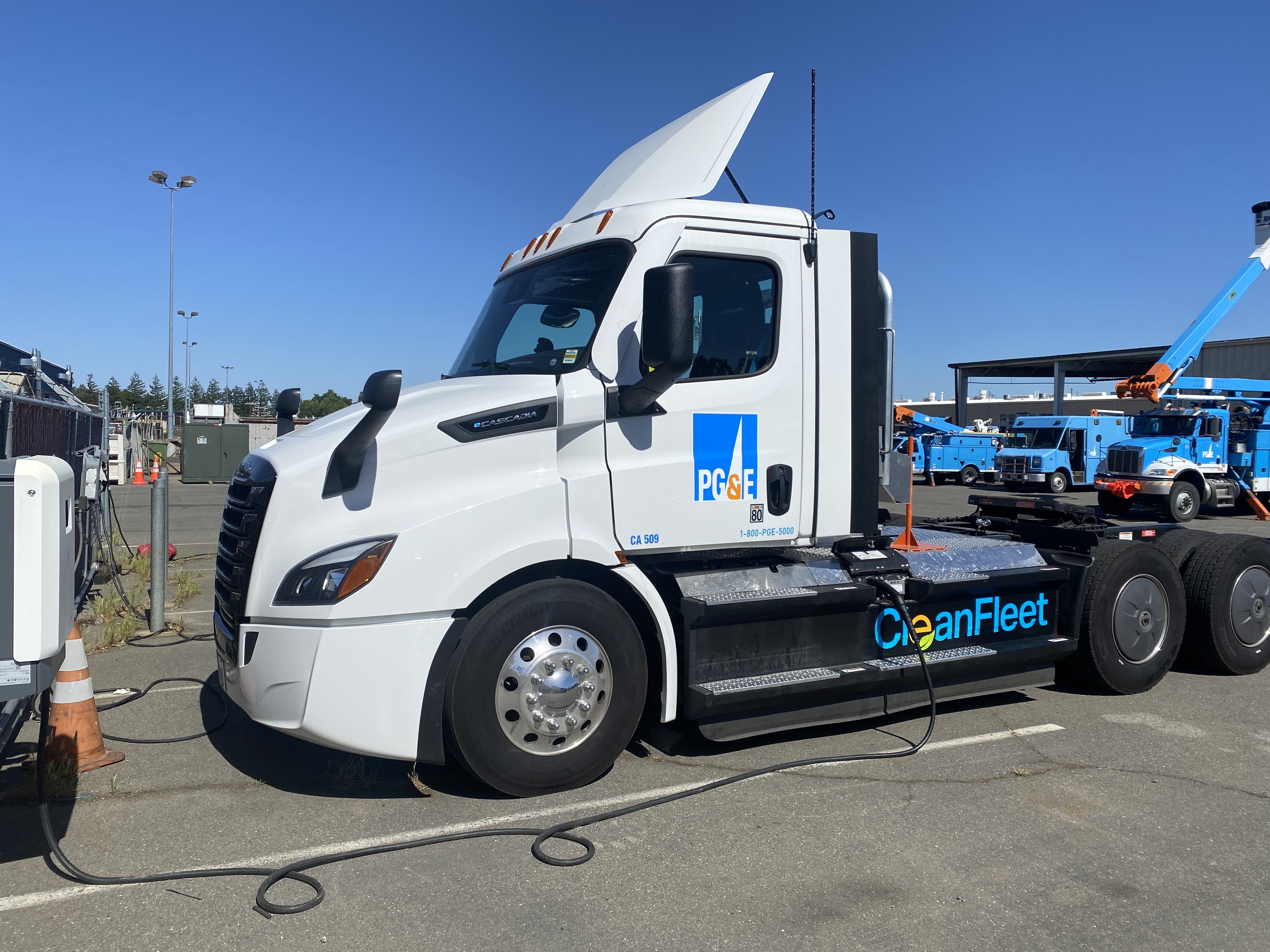 A Freightliner eCascadia truck from PG&E's fleet is shown charging at an ABB eMobility charger.