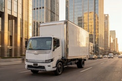 Harbinger's all-new HC Series Cab driving in a downtown setting.