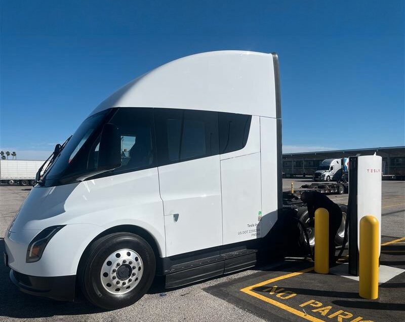 A white Tesla Semi is charging at Tesla's first public Megacharger in Ontario, California.