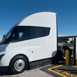 A white Tesla Semi is charging at Tesla's first public Megacharger in Ontario, California.