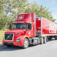Coke Canada Bottling's read Volvo VNR Electric hauling a red Coca-Cola trailer.