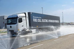 Mercedes-Benz's NextGenH2 hydrogen fuel cell truck undergoes a wet pavement handling test, with water sprayed across the surface to simulate real-world conditions.