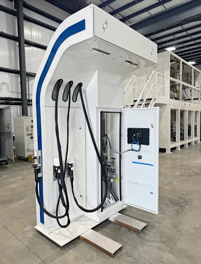 A white hydrogen fuel charging station sits in a warehouse ahead of its deployment.