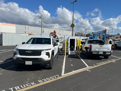 A pair of Chevrolet Silverado EV Work Trucks charging at PG&E's hub via ABB E-Mobility chargers.