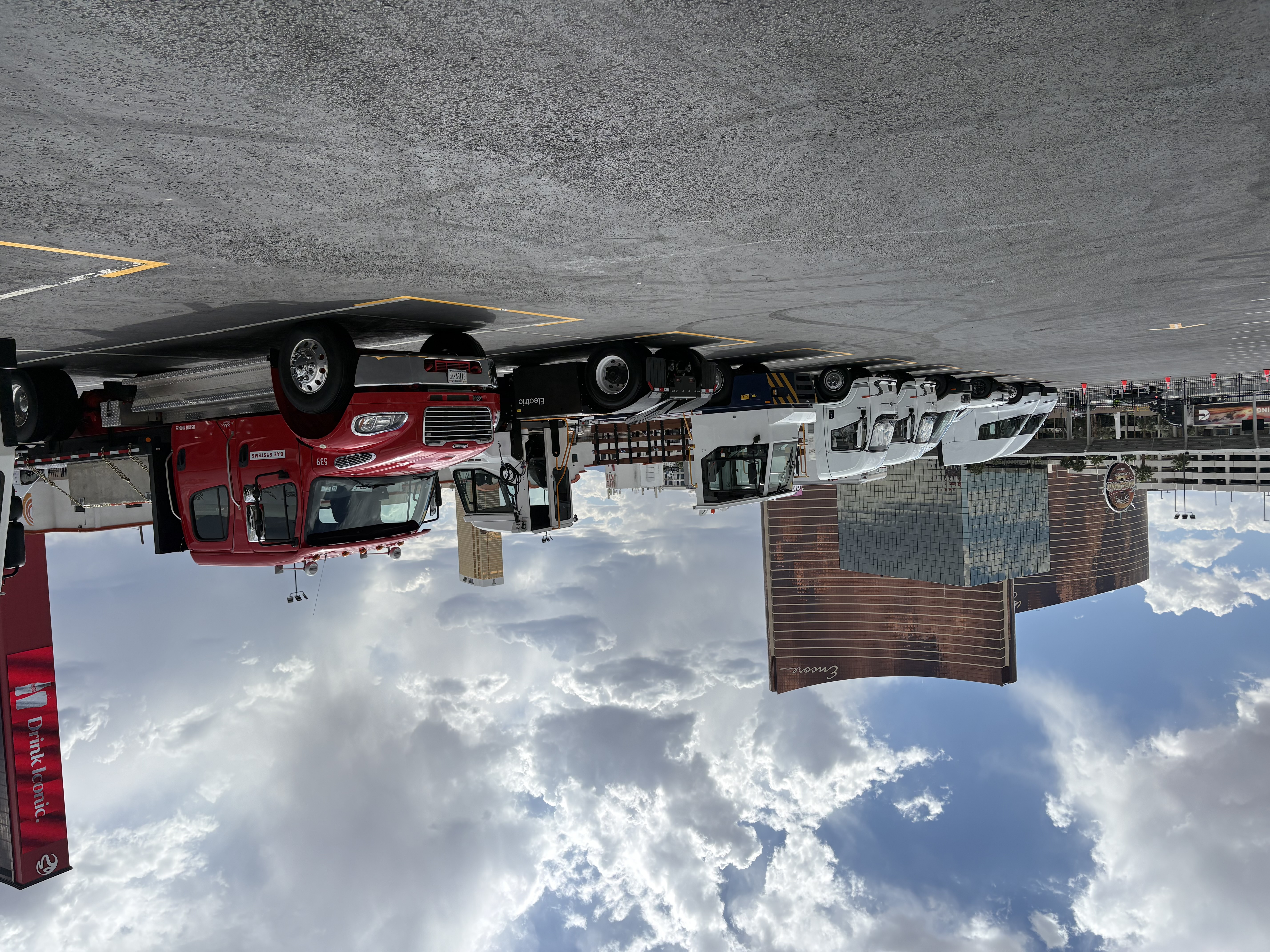 Alternative-powered commercial vehicles parked in an outdoor lot at the 2026 ACT Expo in Las Vegas under a cloudy sky.