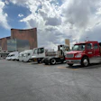 Alternative-powered commercial vehicles parked in an outdoor lot at the 2026 ACT Expo in Las Vegas under a cloudy sky.