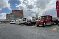 Alternative-powered commercial vehicles parked in an outdoor lot at the 2026 ACT Expo in Las Vegas under a cloudy sky.