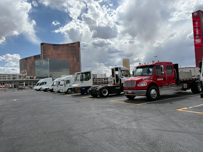 Alternative-powered commercial vehicles parked in an outdoor lot at the 2026 ACT Expo in Las Vegas under a cloudy sky.