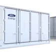 A display of Ford Energy battery storage containers and industrial power modules.