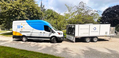 A battery-electric Walmart delivery van connected to a SparkCharge mobile charging unit for on-demand fleet charging.