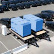 A pair of SparkCharge mobile, off-grid charging units on trailers parked at an electric vehicle fleet lot.