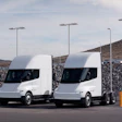 Two white Tesla Semis parked at a charging station.