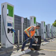 A worker connects the new Fluke FEV500 to a fast charger at a fleet charging depot.