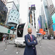 Einride CEO Roozbeh Charli stands outside Nasdaq in Times Square on June 10, 2026, with an autonomous battery-electric truck parked behind him.