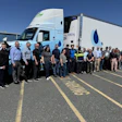 Employees from Optimus Technologies, Perdue Farms, and the Maryland Soybean Board stand in front of a biodiesel-powered Volvo semi-truck.