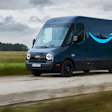 An Amazon Prime branded Rivian Electric Delivery Vehicle (EDV) driving a rural route in Europe.