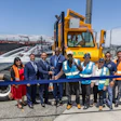 California State Transportation Agency (CalSTA) Secretary Toks Omishakin cutting a blue ribbon with state and port officials at the Port of Long Beach.