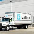 A white Maersk delivery truck sits outside a warehouse loading dock, highlighting the company’s expanding ground freight operations.