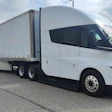 Paper Transport Inc.'s Tesla Semi Long Range is shown with a loaded trailer in an industrial yard during the company's Chicago pilot program.