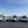 Three battery-electric Workhorse W56 step vans in a parking lot.